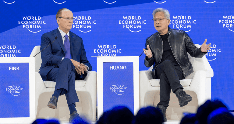 Jensen Huang and Larry Fink speaking on stage at the World Economic Forum during a fireside chat on artificial intelligence.