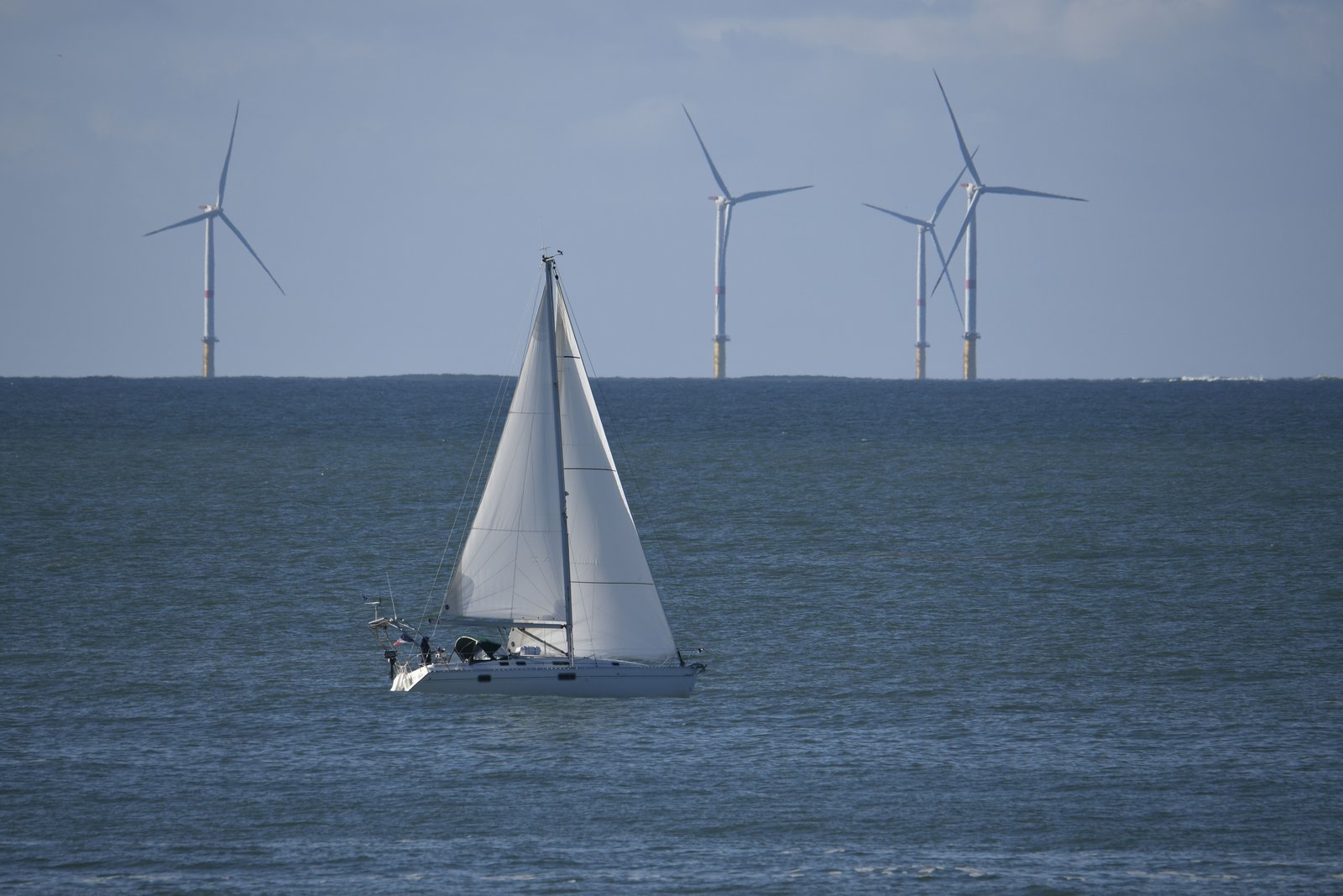 Sailboat leaning into the wind on open water, a metaphor for rebalancing a portfolio back to its target course