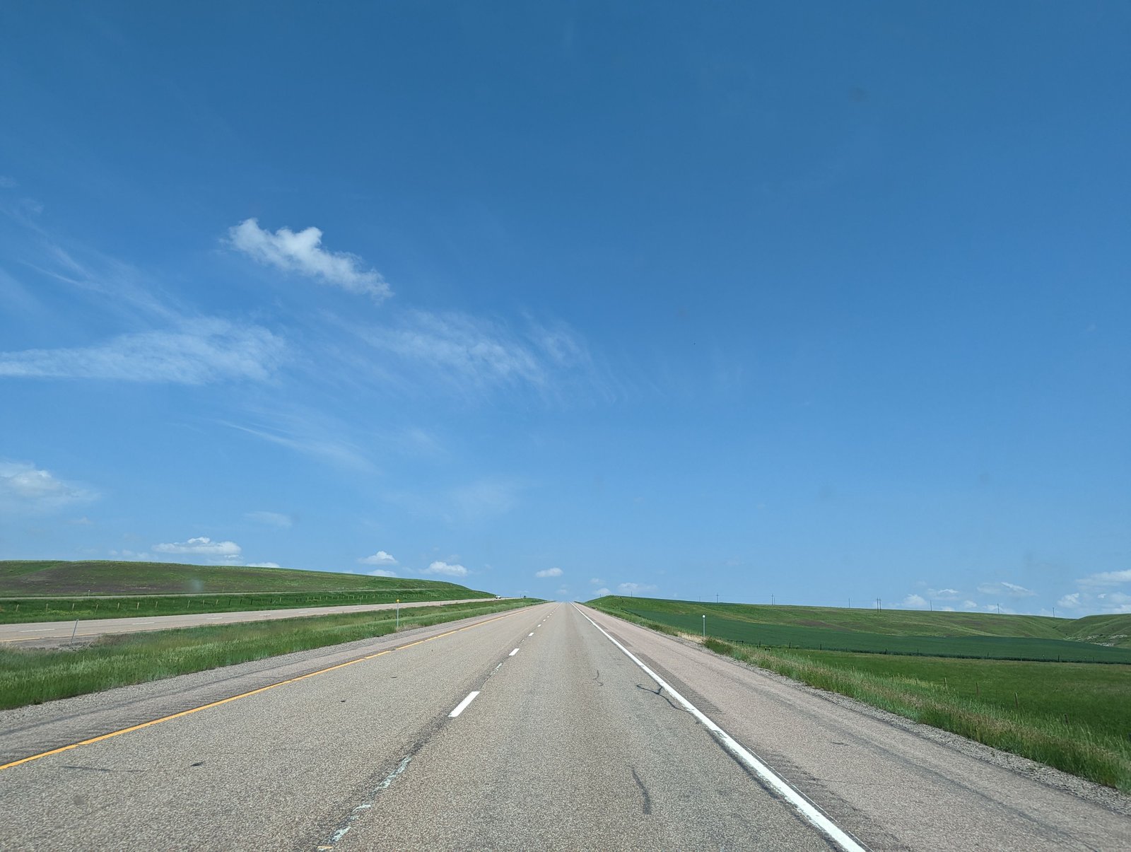 Long straight road stretching to the horizon, symbolizing a long investing time horizon