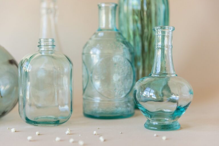 Vintage clear glass bottles side by side on a light surface, representing an index mutual fund and an ETF as different wrappers for similar holdings