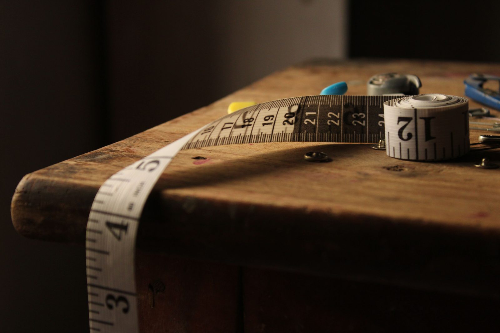 Close-up of a measuring tape on wood, representing measuring modified AGI against the Roth IRA income limits