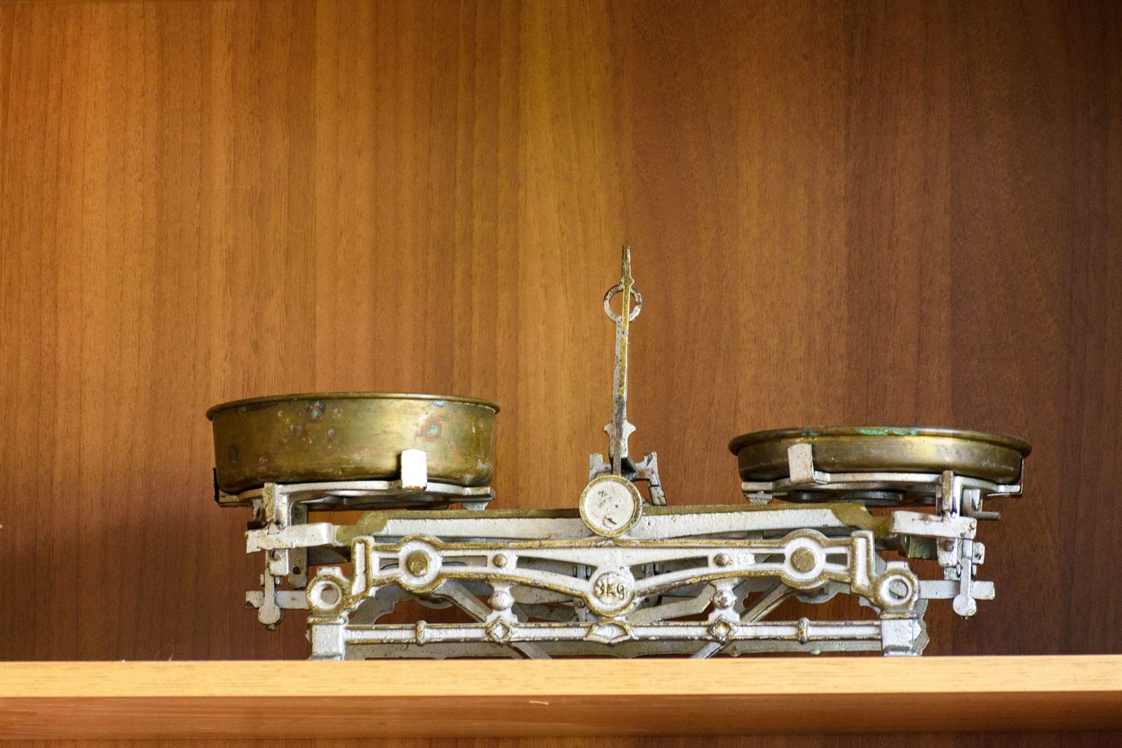 Vintage brass balance scale with two pans, representing the stock and bond mix inside a three-fund portfolio