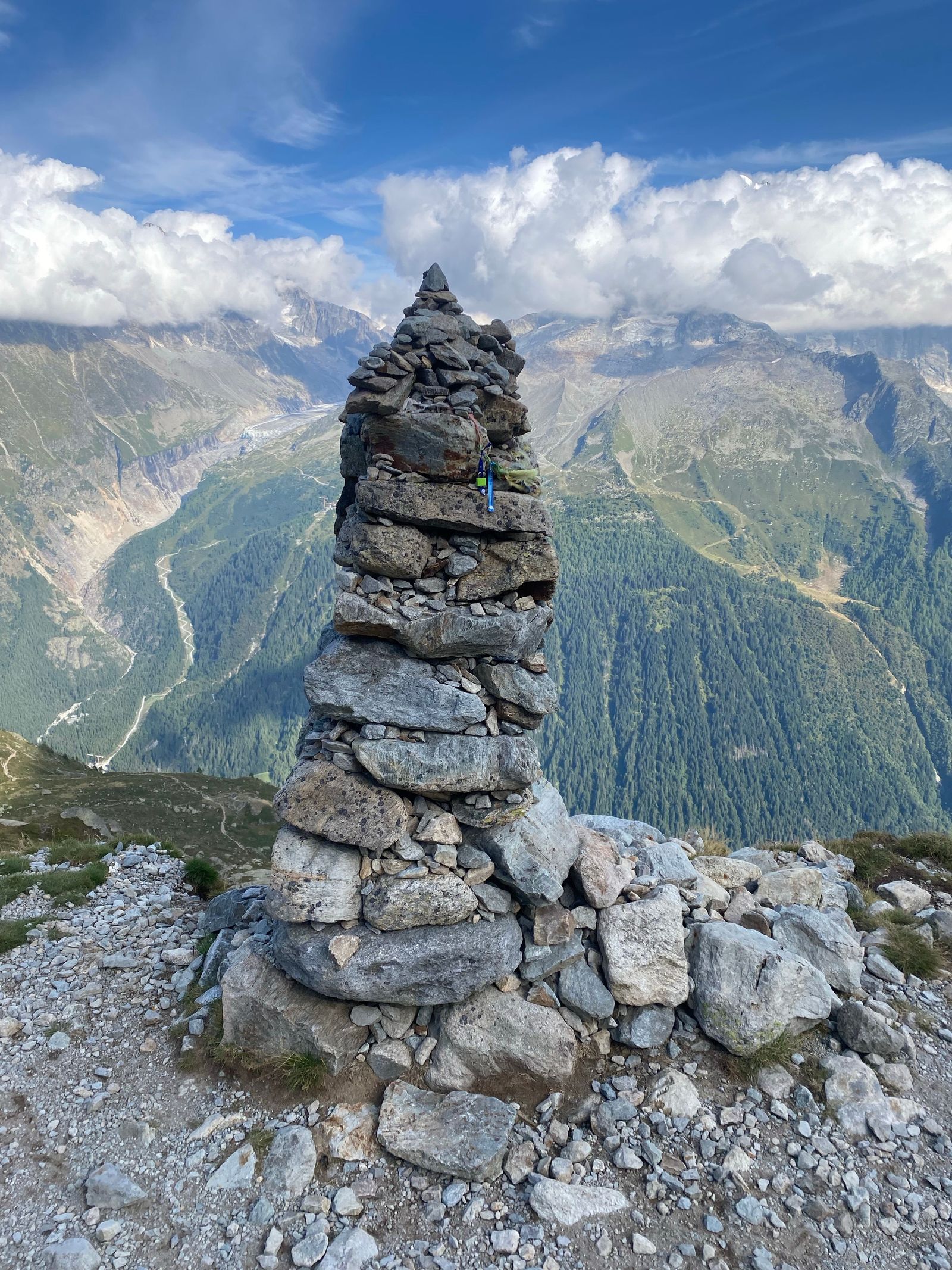 Stone cairn marking a hiking trail, a metaphor for periodically rebalancing a three-fund portfolio back to target